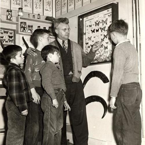 [August Heisch, educational director of the Columbia Park Boys Club with James Morgan, Bobby Stranger, Leonard Wallace and Richard Ott at the club's natural history museum]