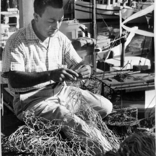 [Tom Balistrei mending his nets at Fisherman's Wharf]