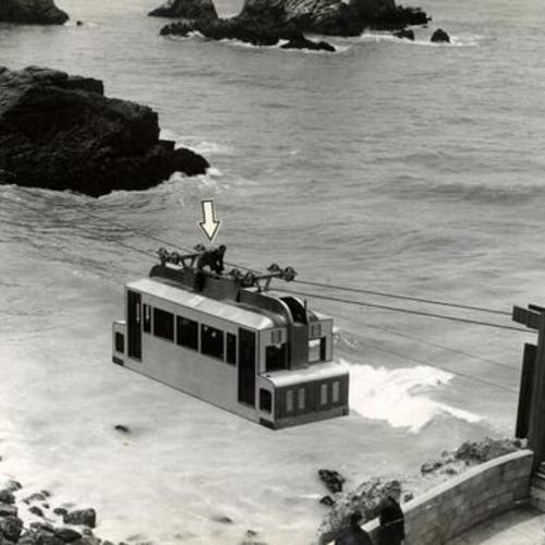 [Bob Gilman riding atop the Sky Tram as it travels towards its Point Lobos landing dock]