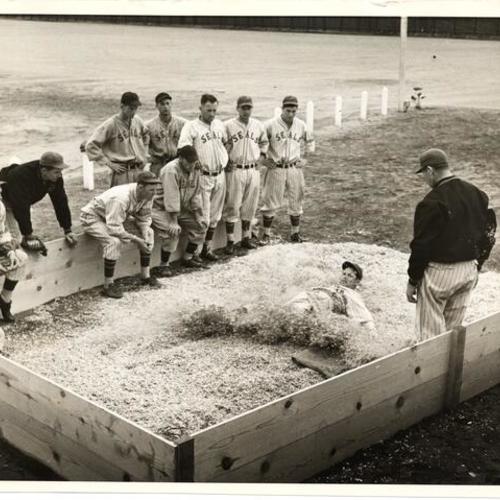 [Players on the San Francisco Seals training in a sliding pit]