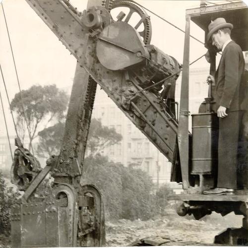 [Paul Armstrong, president of the San Francisco Federal Business Association, operating heavy machinery at the construction site of the Federal Building in the Civic Center]