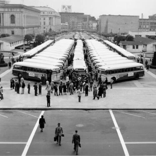 [Buses gather in the Civic Center across from City Hall]