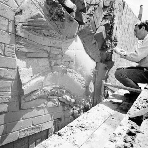 [Artist Jacques Overhoff working on the sculpture Brick Scrafitto Wall on the façade of the Bayview/Anna E. Waden Branch Library]