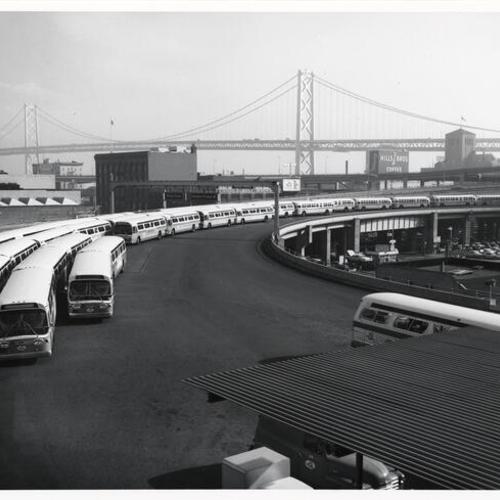 [Buses parked near Transbay Transit Terminal, with view of Bay Bridge in background]