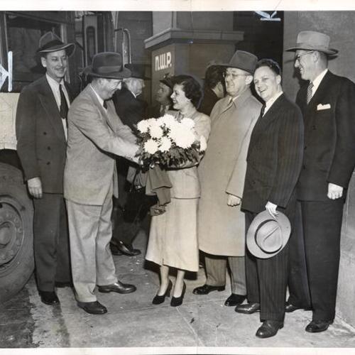 [Harry Richardson of the State Harbor Commission greeting Kay Mattos, "Miss Marin Commuter," to new Greyhound terminal located at the Ferry Building]