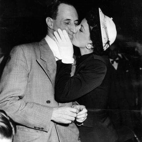[Harry Bridges being kissed by his wife, Nancy]