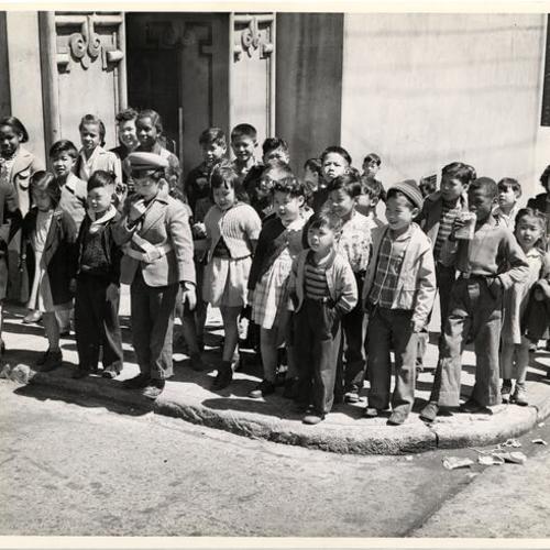 [Students from Commodore Stockton Elementary School standing on a street corner near the school]