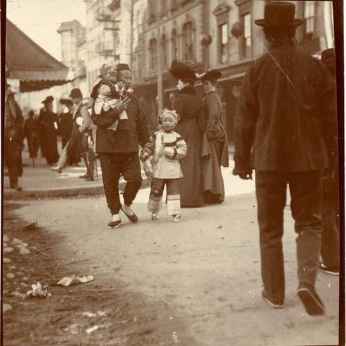 [Man walking with two children in Chinatown]