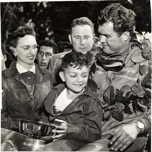 [Jack McAfee, winner of The Guardsmen Trophy Race, being congratulated by his wife and young Ronnie Parravano]
