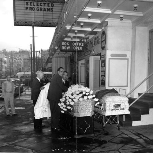 [Unidentified men with funeral caskets outside the Green Street Theater]