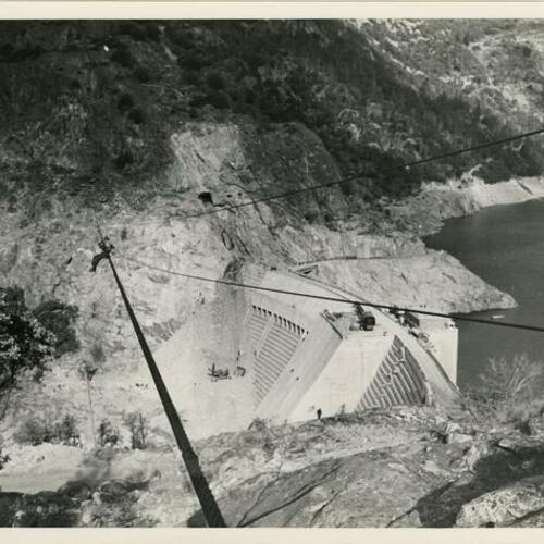 Worker on cable over the O’Shaughnessy Dam during construction