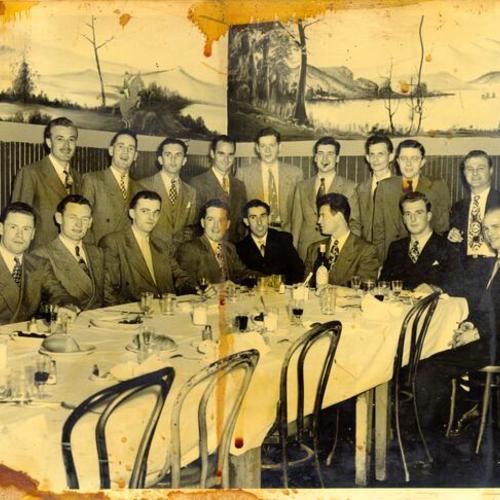 [Group of men posing for a photograph in a restaurant in North Beach]