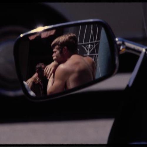 View of person through rearview mirror