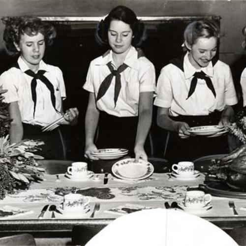 [Camp Fire Girls Virginia Perryman, Carol Thompson, Katherine Hoass, Helena Cannon and Ann Graber setting the table for the dinner they gave for their dads at the clubhouse]