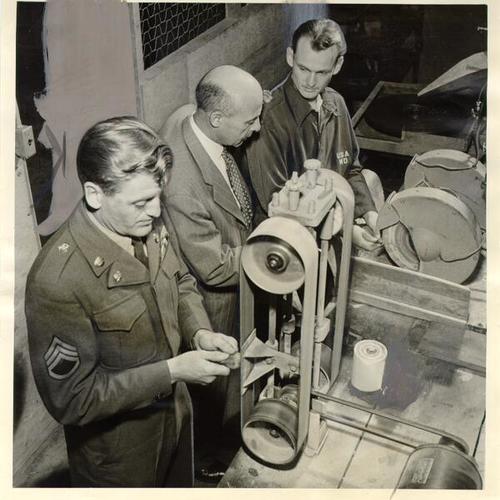 [Sergeant Robert J. Perkins, H. A. Loomis and Private Robert Imbeau in the lapidary shop at the Presidio of San Francisco Y.M.C.A.]