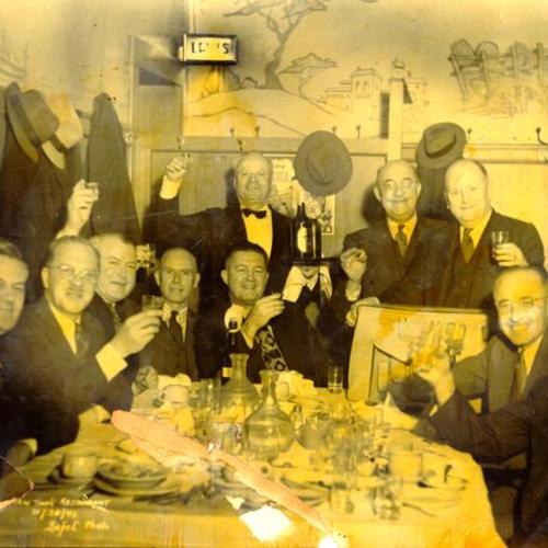 [Unidentified group of men posing for a picture at the New Tivoli restaurant]