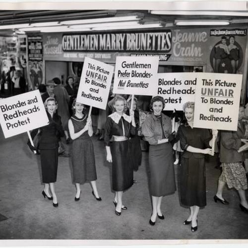 [Bay area models Helen Scott, Shirley Ryder, Loretta Ferrier, Jeanne Roberts, and Chris Davidson protesting the movie 'Gentlemen Marry Brunettes']