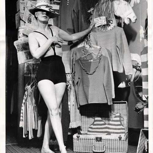 [Model Evelyn Fry wearing a topless bathing suit in a North Beach clothing store]