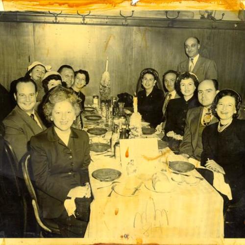 [Group of people posing for a photograph in a restaurant in North Beach]