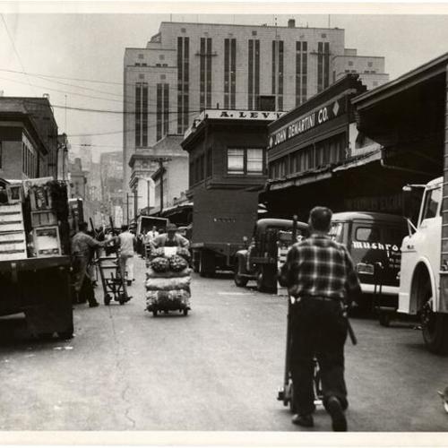 [Deliveries being made to produce markets on Washington Street, near Davis]