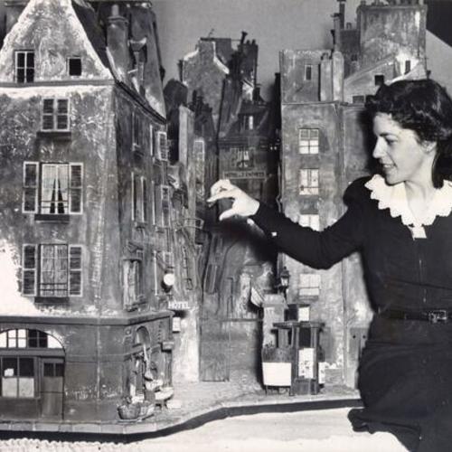[Dorothy Bailey looking at a model on display at the City of Paris department store]