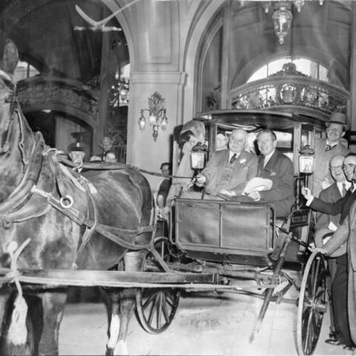 [Mayor Rossi and Major Benjamin H. Namm on a carriage outside the Palace Hotel]