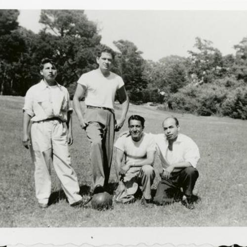 [Portrait of four men playing soccer at Balboa Park]