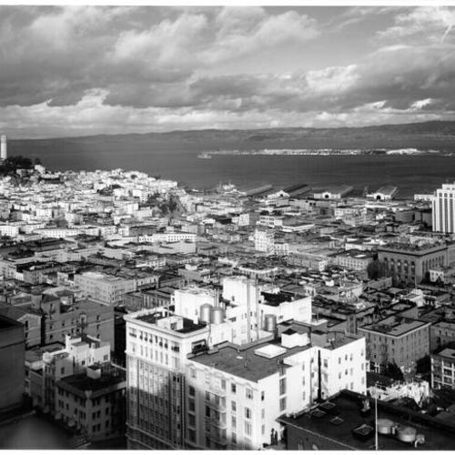 [View of downtown San Francisco showing Coit Tower on left and Treasure Island in distance]