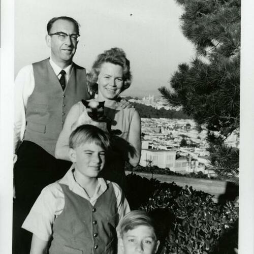 [Pat with her husband and children at home]