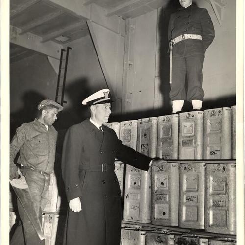 [Coast Guard officer inspecting ammunition on a ship at a San Francisco port]