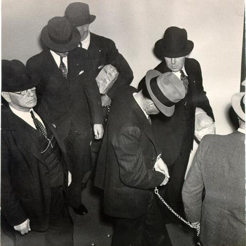 [Convict Milton Pettijohn (with head down), during a trial of two other prisoners who made a failed escape attempt from Alcatraz Prison in May, 1938]