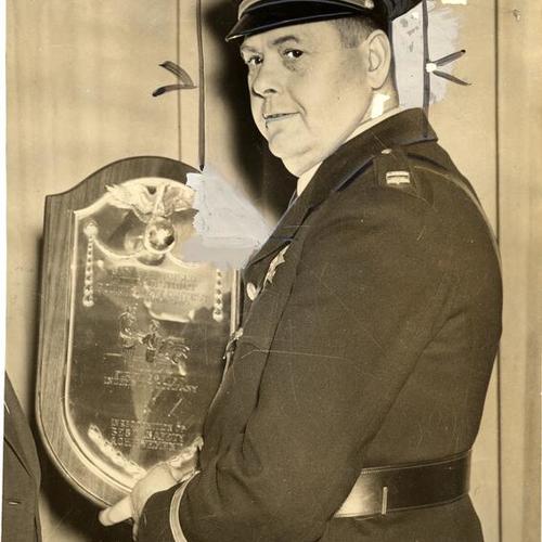 [Captain Bernard J. McDonald holding award]