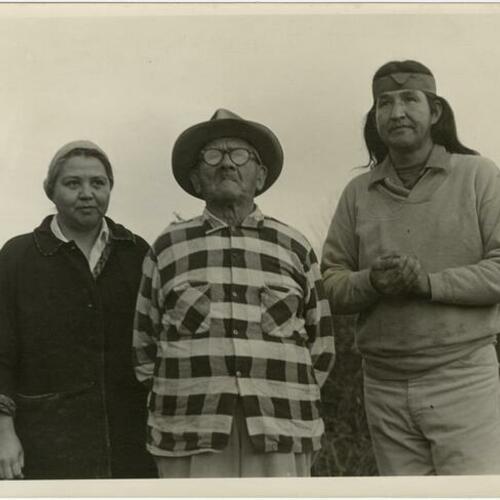 Portrait of Native American fisherman (right) with his wife and grandfather