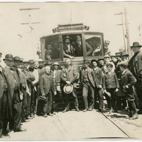 [Mayor Eugene E. Schmitz driving the first trolley car to run in San Francisco after the 1906 earthquake and fire]