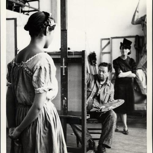 [Artist Diego Rivera in his Mexico City studio with his Indian model, Nieves Orozco, and unidentified woman]