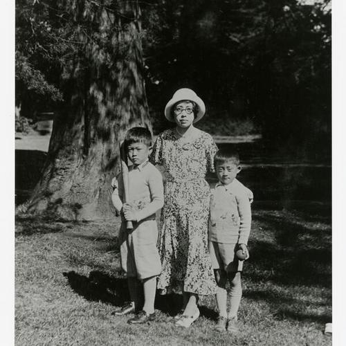 [Two brothers and mother with baseball bat and ball in Golden Gate Park]