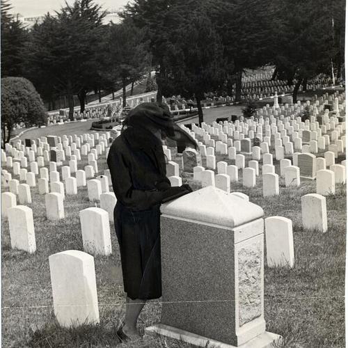 [Woman mourning at a grave in Presidio National Cemetery]