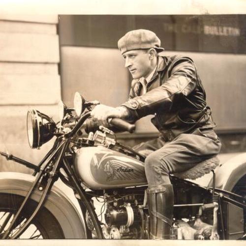 [Leslie Van Demark, motorcycle speed king, posing on a motorcycle, preparing to be among the first to cross the San Francisco-Oakland Bay Bridge in the opening celebration]