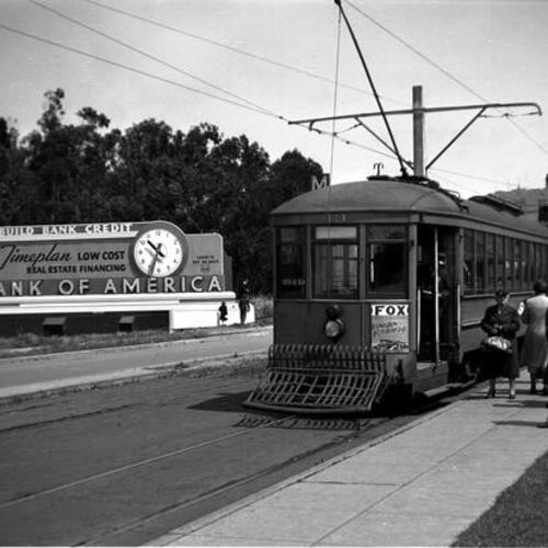 [West Portal avenue looking north from St. Francis Circle showing Muni "M" line car 43 discharging passengers]