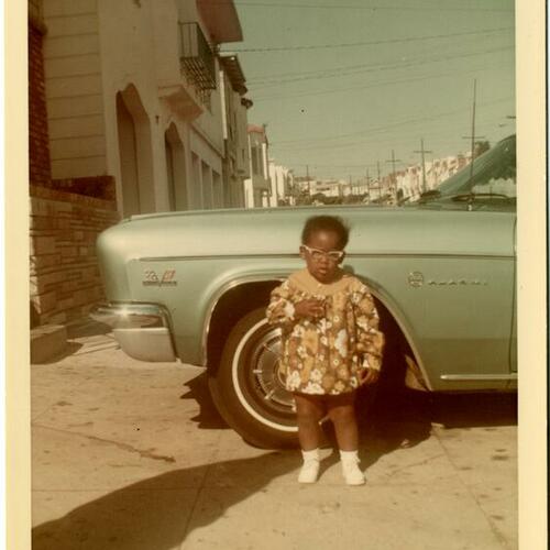 [Beverly in front of her parents' house]