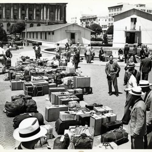 [Group of Chinese technicians preparing to leave for China await their departure near the Temporary Barracks located in the Civic Center Plaza]