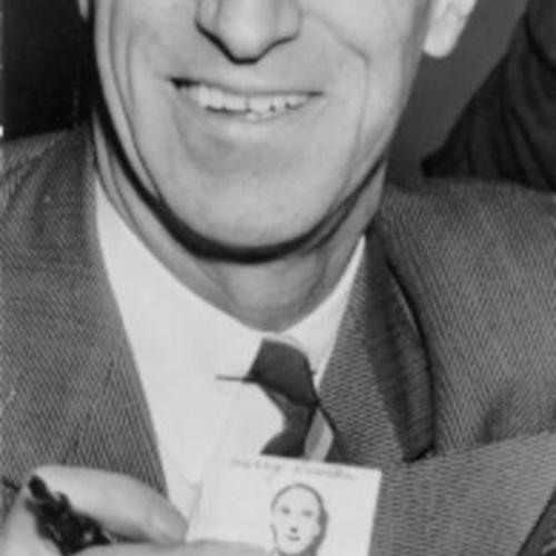 [Harry Bridges showing his identification photo as he applied for United States citizenship]