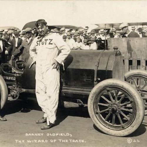 [Barney Oldfield posing with race car at the Panama-Pacific International Exposition]