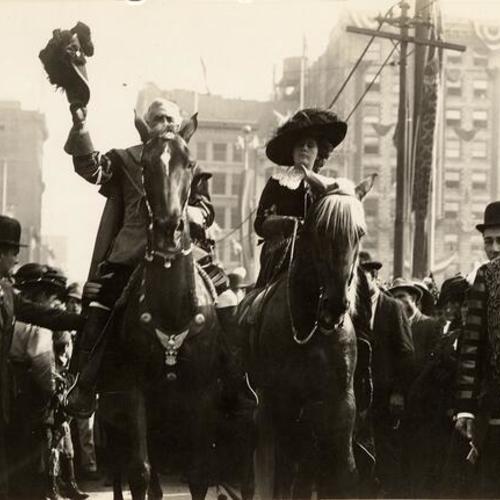 [Queen Virgilia and Don Gaspar de Portola on horseback saluting the crowds, Parade from Portola Festival, October 19-23, 1909]