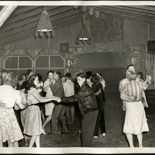 [People dancing on the main lodge at Camp Mather]