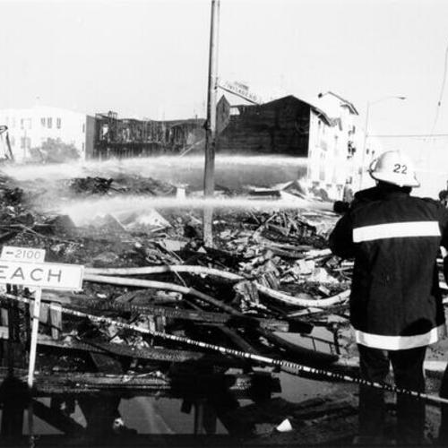 [Firefighters putting out a fire at Divisadero and Beach streets caused by the October 17, 1989 Loma Prieta earthquake]