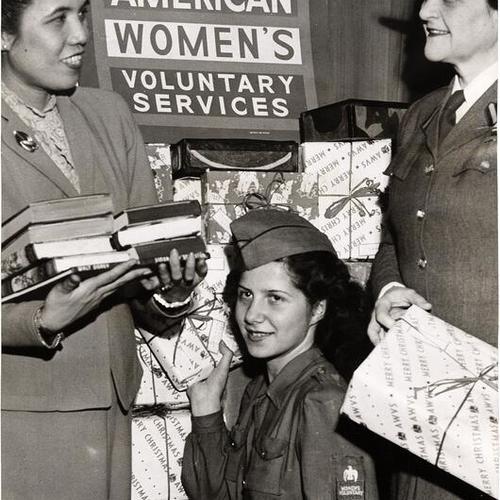[Miss Helen Benitez, Doris Stuhr and Mrs. Ryer Nixon displaying packages sent by the American Women's Voluntary Services (AWVS) to the people of the Philippine Islands]