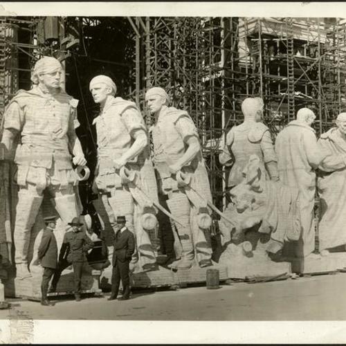 [Statues being prepared for placement on tower at the Panama-Pacific International Exposition]