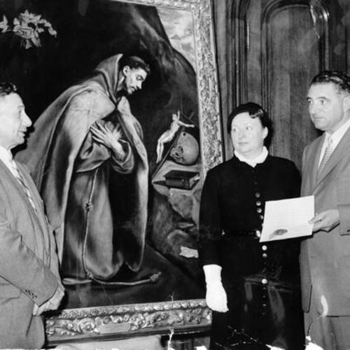 [John Brucate, Clarissa S. McMahon and Mayor Christopher standing in front of a painting of Saint Francis of Assisi]