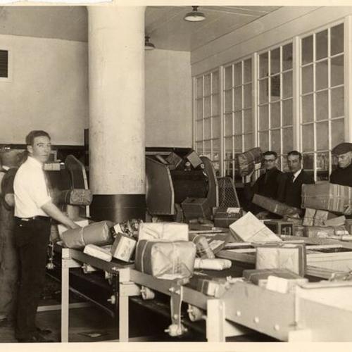 [Postal service employees working in the new Ferry station Post office]